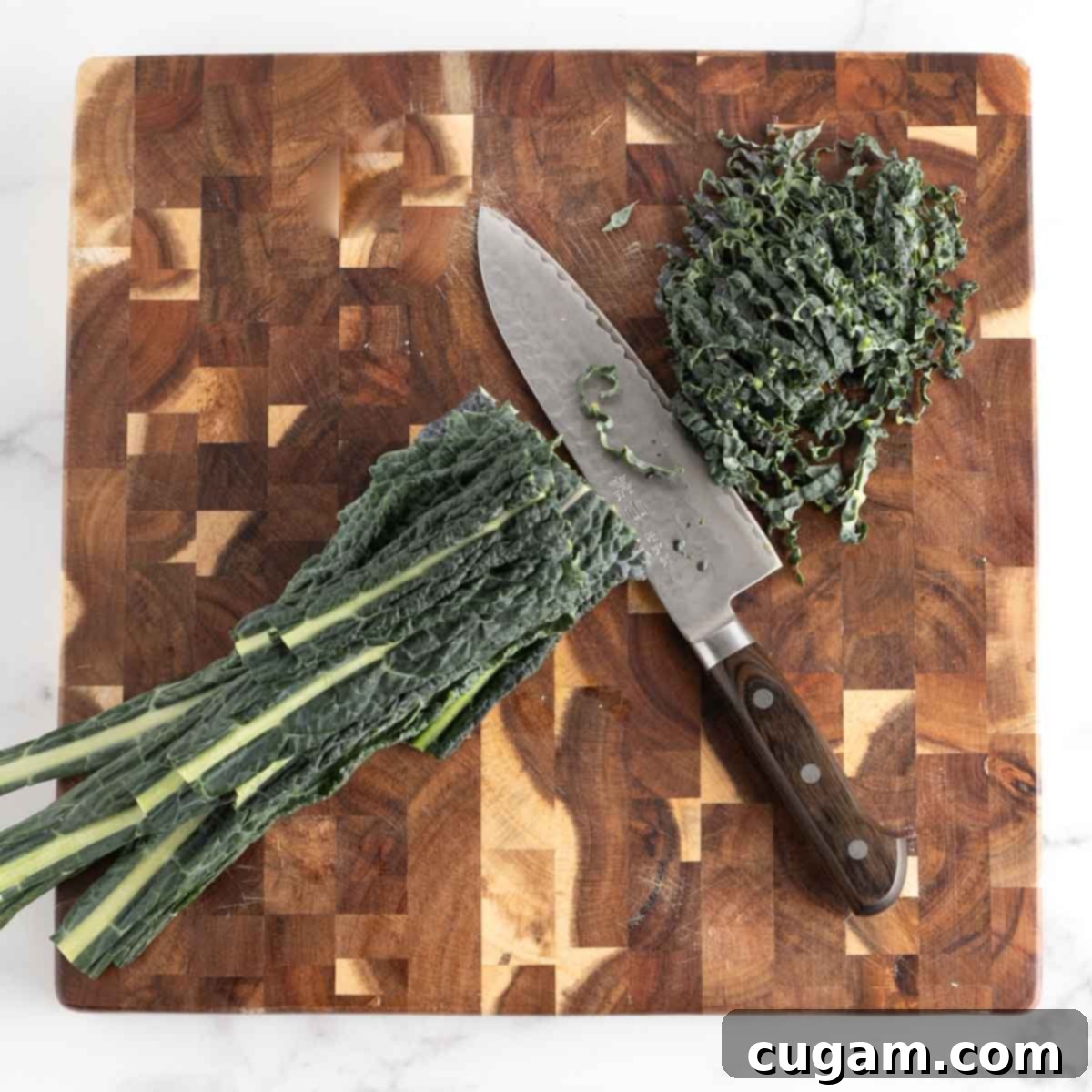 Vibrant Radicchio Chickpea Salad with Tahini 7 Thinly slicing lacinato kale leaves that are stacked.