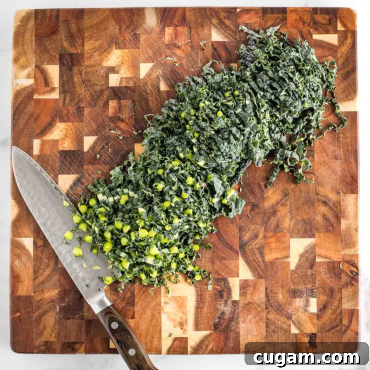 Vibrant Radicchio Chickpea Salad with Tahini 8 Julienne sliced lacinato kale on a butcher block cutting board.