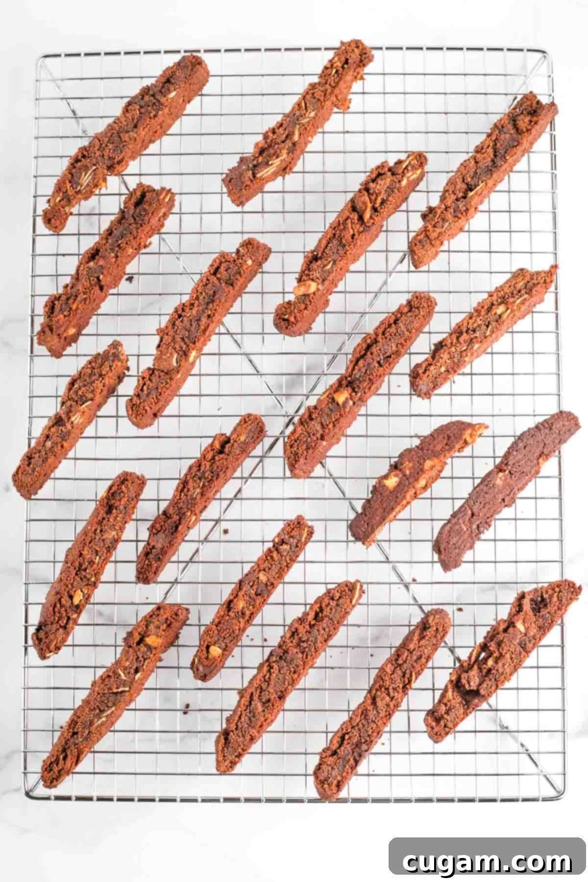 Freshly baked chocolate almond biscotti cooling on a wire rack, perfect for achieving maximum crispness.