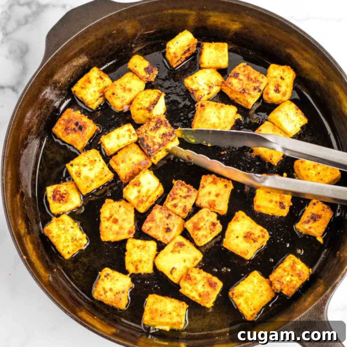 Sticky Sweet and Sour Crispy Tofu 18 Crispy golden brown tofu cubes cooking undisturbed in the skillet.