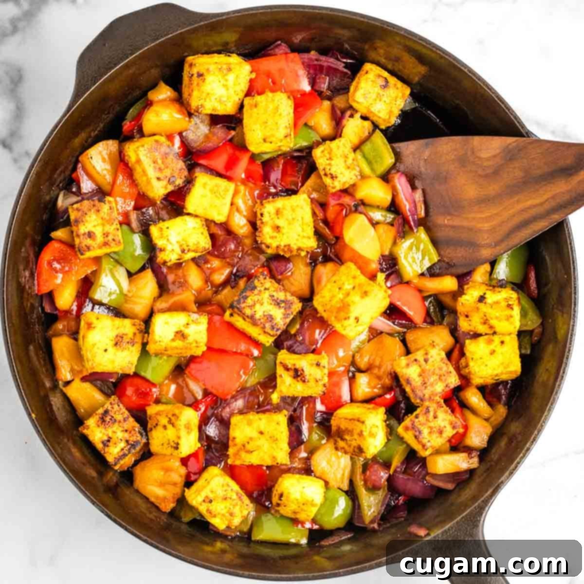 Sticky Sweet and Sour Crispy Tofu 19 Cooked vegetables and pineapple returned to the pan with crispy tofu, ready for sauce.