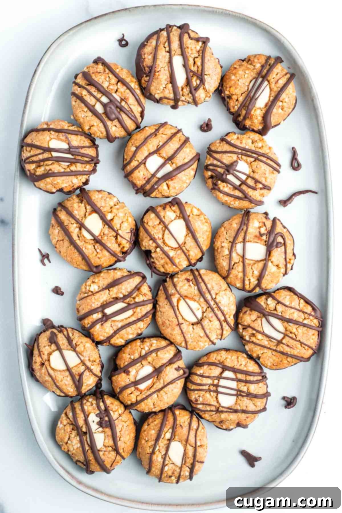 Decadent Vegan Almond Macaroons Enrobed in Chocolate 2 Almond cookies with chocolate dipped bottoms and chocolate drizzled tops.