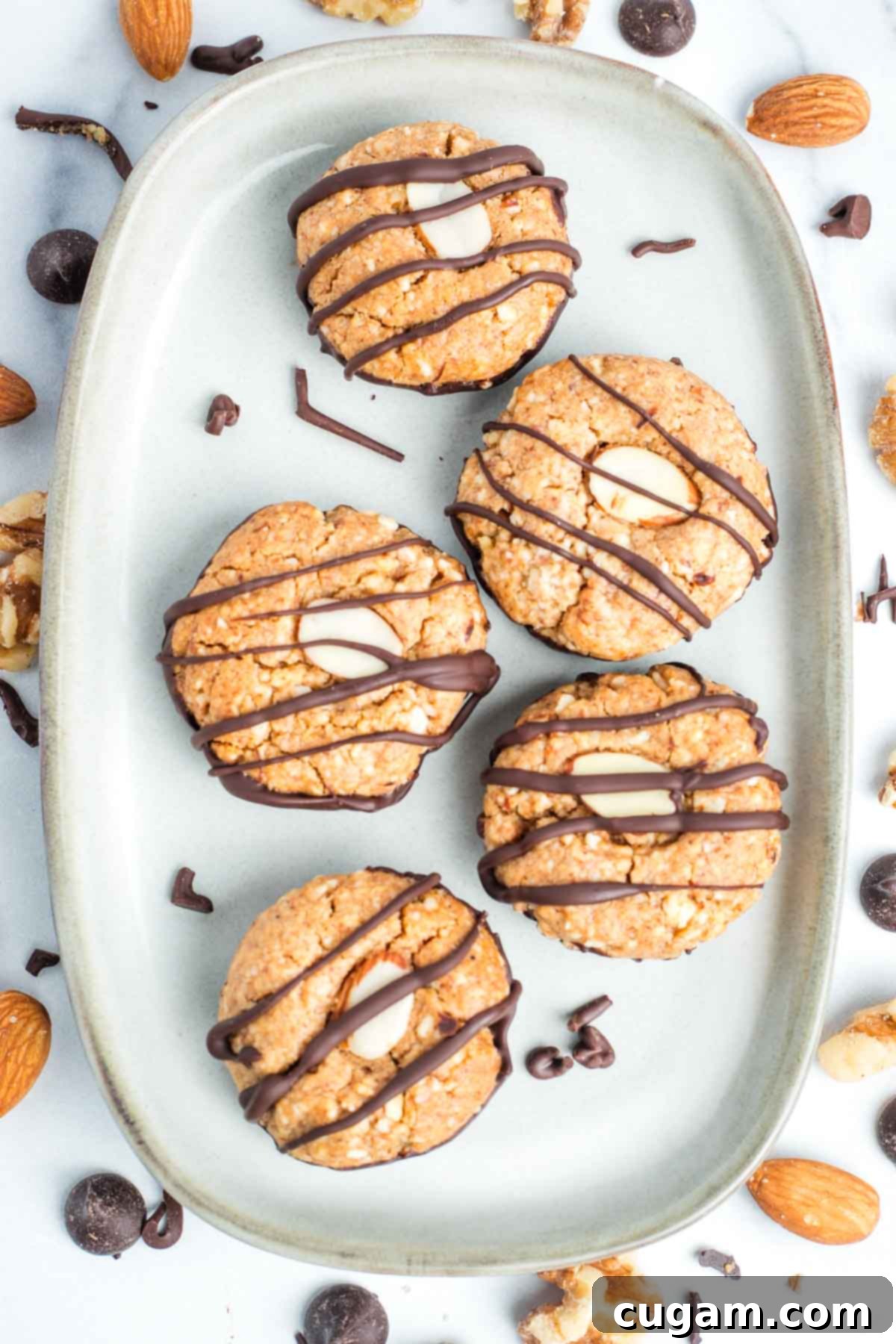 Decadent Vegan Almond Macaroons Enrobed in Chocolate 20 Almond macaroons with a decorative almond slice and chocolate drizzle.