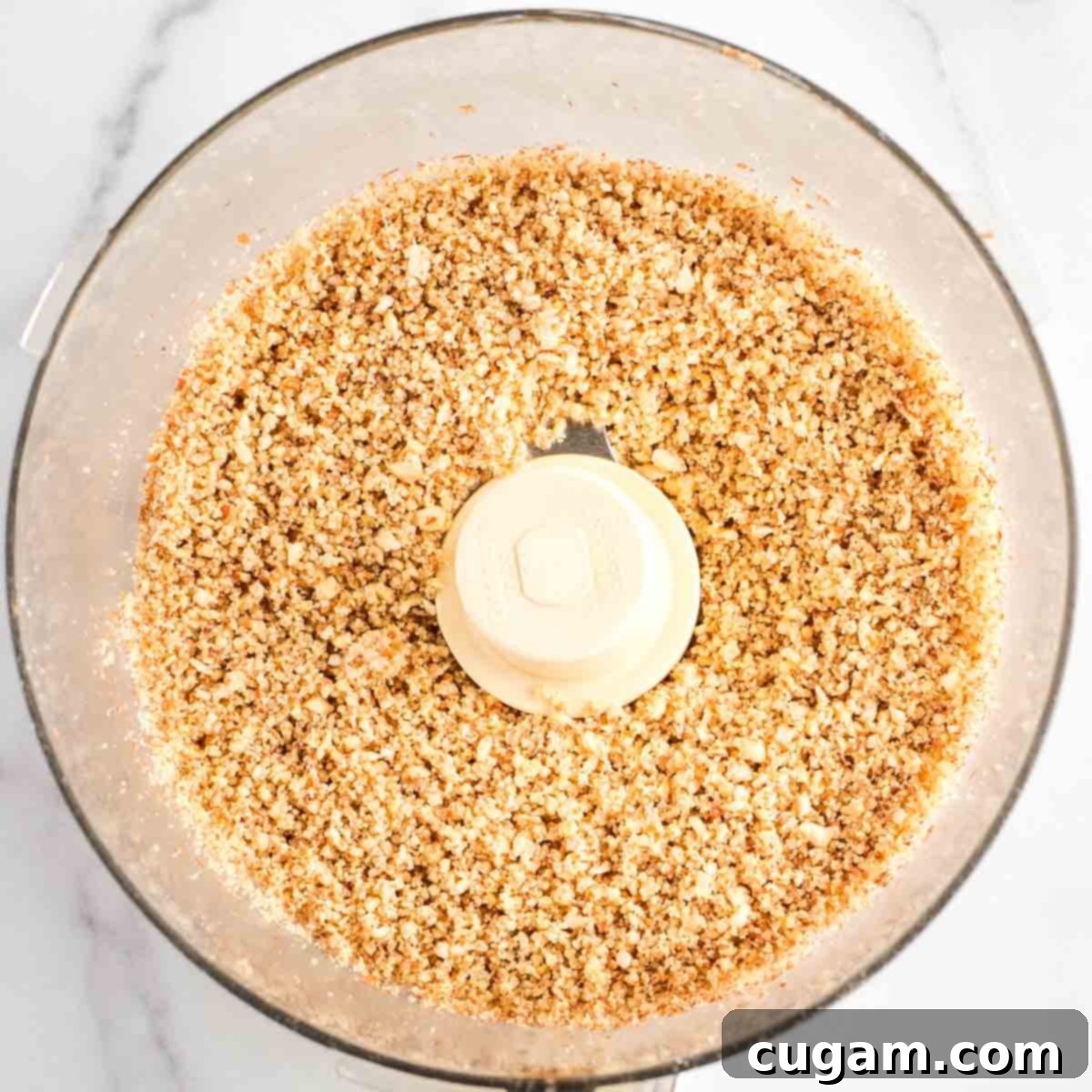 Decadent Vegan Almond Macaroons Enrobed in Chocolate 7 Crumbly, coarse grind of nuts in the bowl of a food processor.