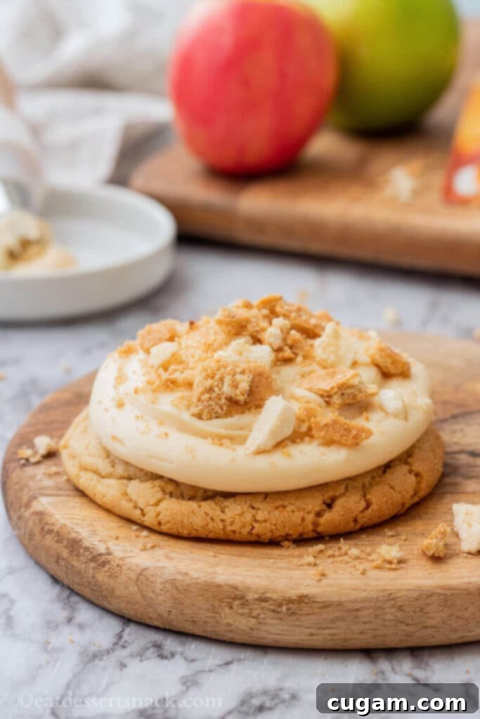 Baked caramel apple cookie on wood cutting board. 