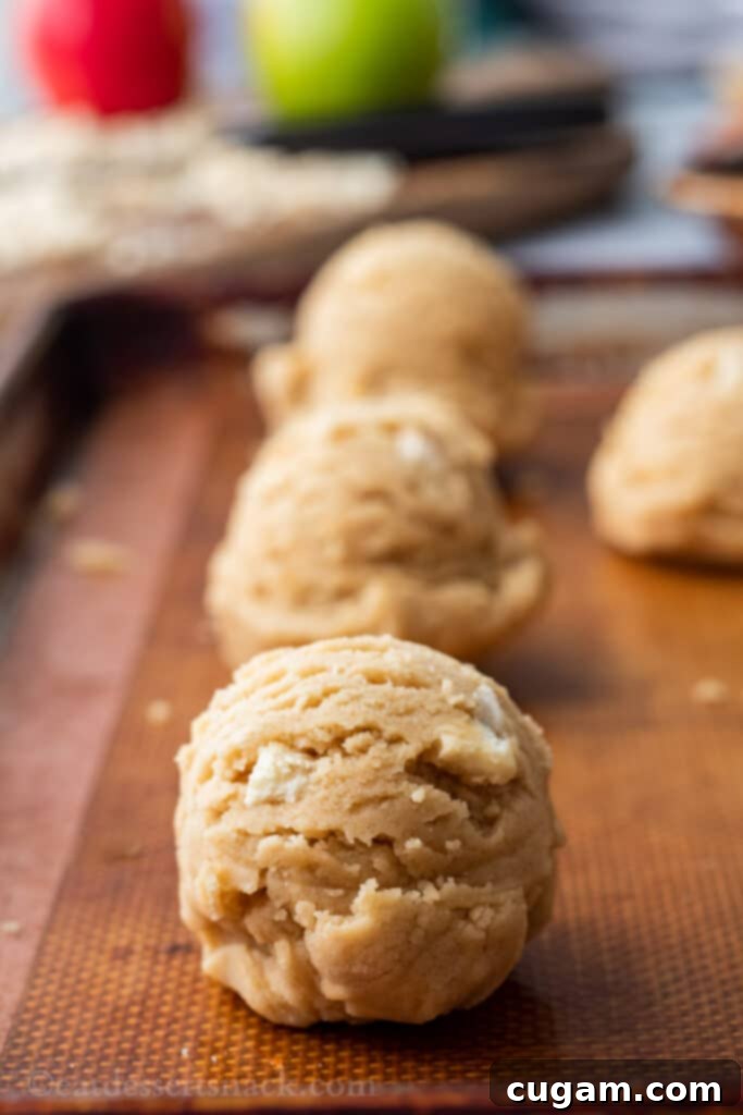 Raw caramel apple cookie dough ball on baking mat. 