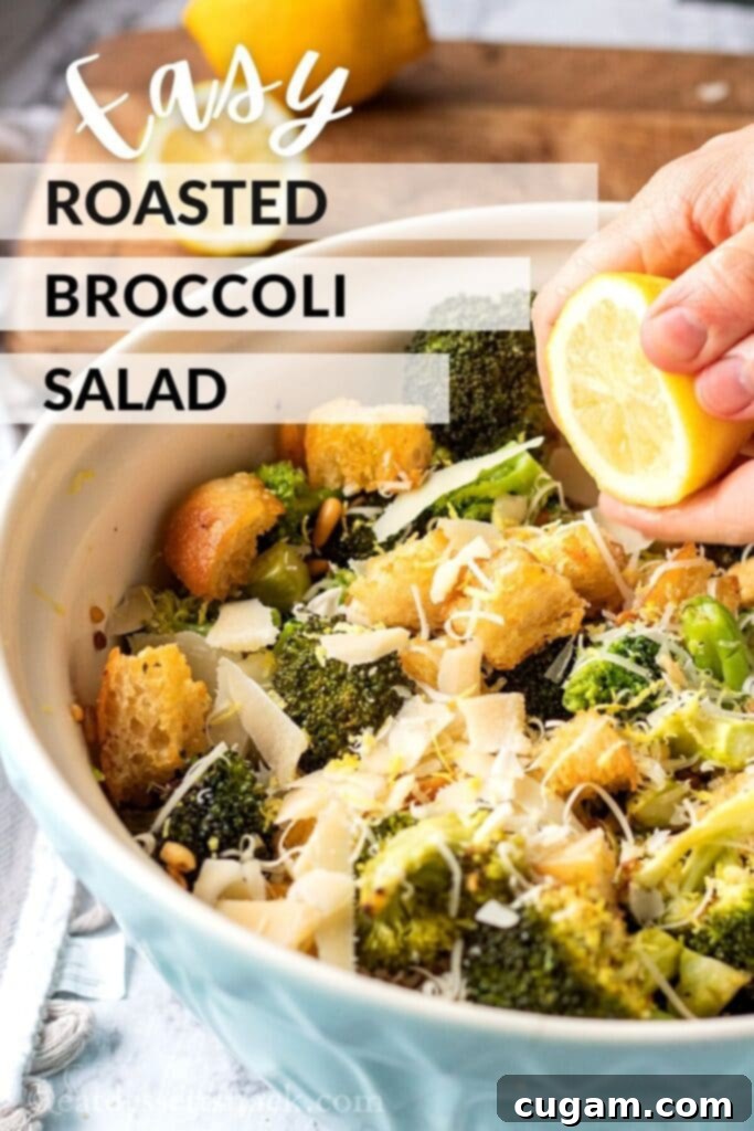 Cooked broccoli salad in blue bowl with lemon, text overlay reads "easy roasted broccoli salad". 