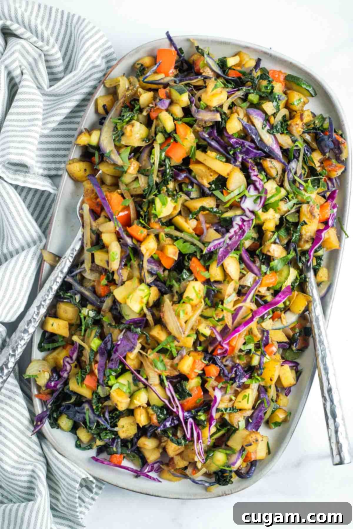 Effortless Vegan Potato and Veggie Skillet 2 Vibrant vegetable and potato hash showcasing colorful cabbage, red peppers, kale, and zucchini, perfectly cooked in a skillet.