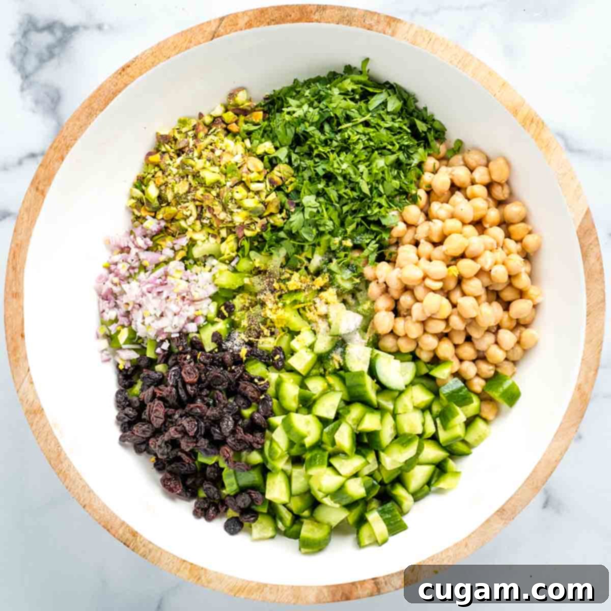 Chickpeas, cucumber, pistachios, fresh parsley, shallot and raisins with lemon zest, salt and pepper.