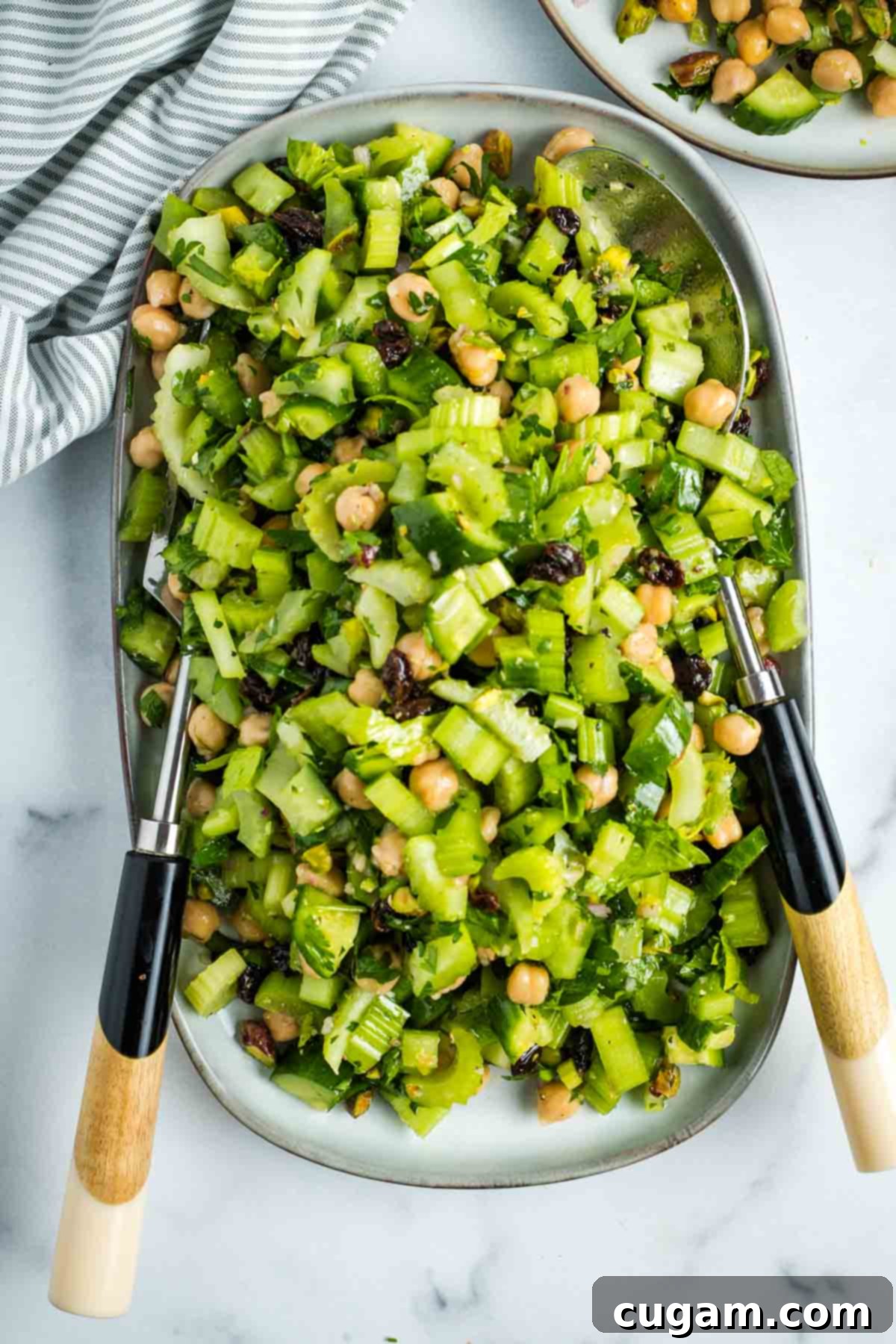 Chopped celery salad with raisins and pistachios, parsley and chickpeas. 