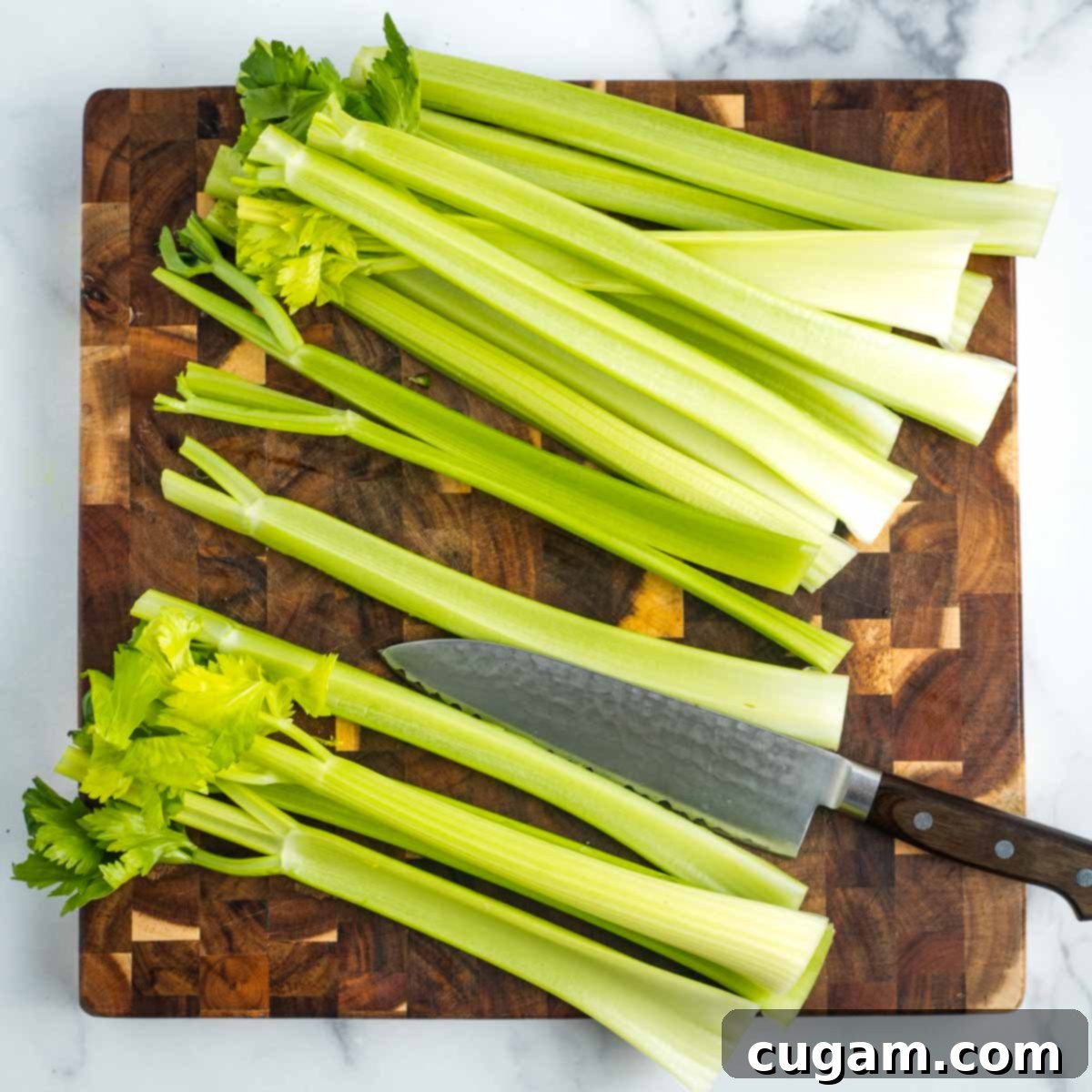 Cutting celery stalks in half lengthwise. 