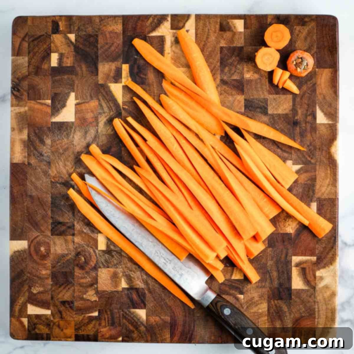Cutting carrots into long strips. 