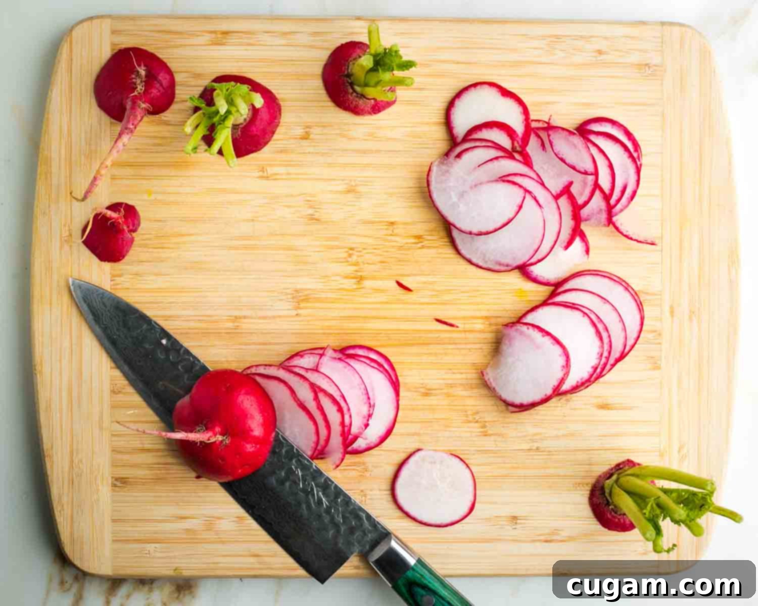 Knife making thin slices of radish.