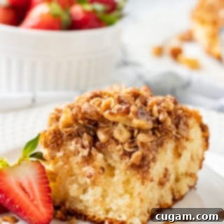 Irresistible Streusel Coffee Cake 3 Slice of classic coffee cake on a white plate with strawberry.