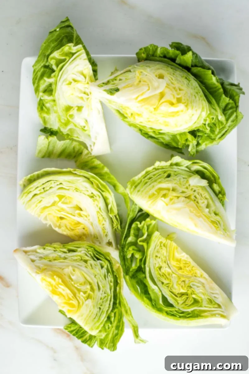 6 wedges of iceberg lettuce on a platter.