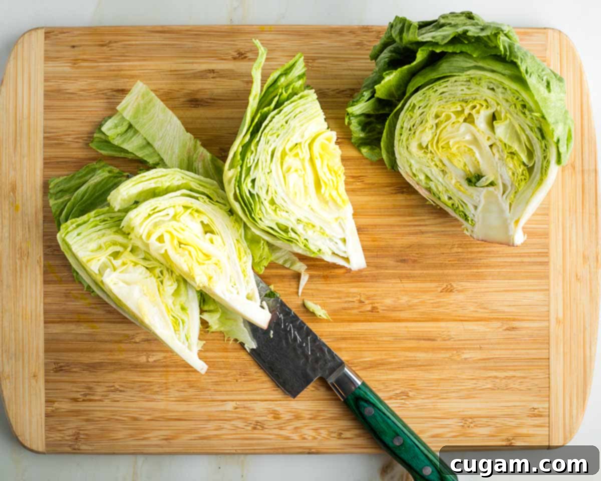 Iceberg lettuce head, cut in half and then the half cut into thirds through the core. 