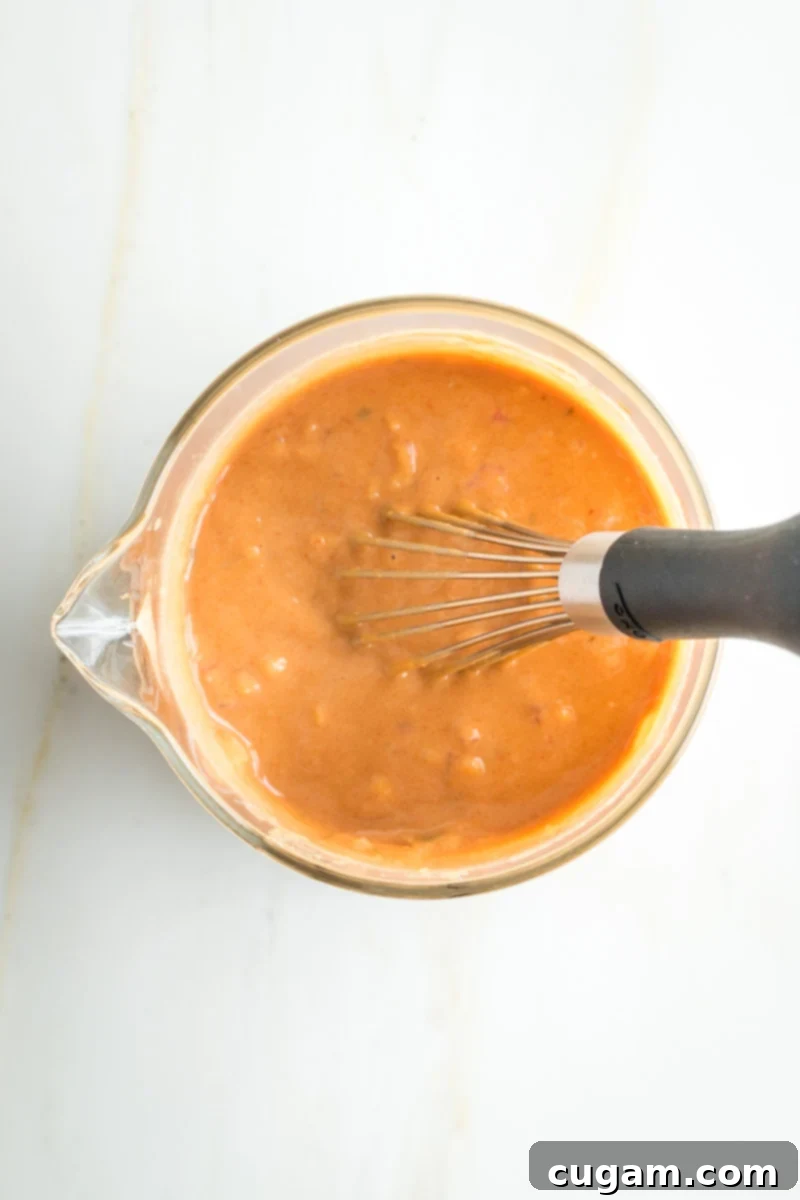 Whisking together ingredients for Russian Dressing. 