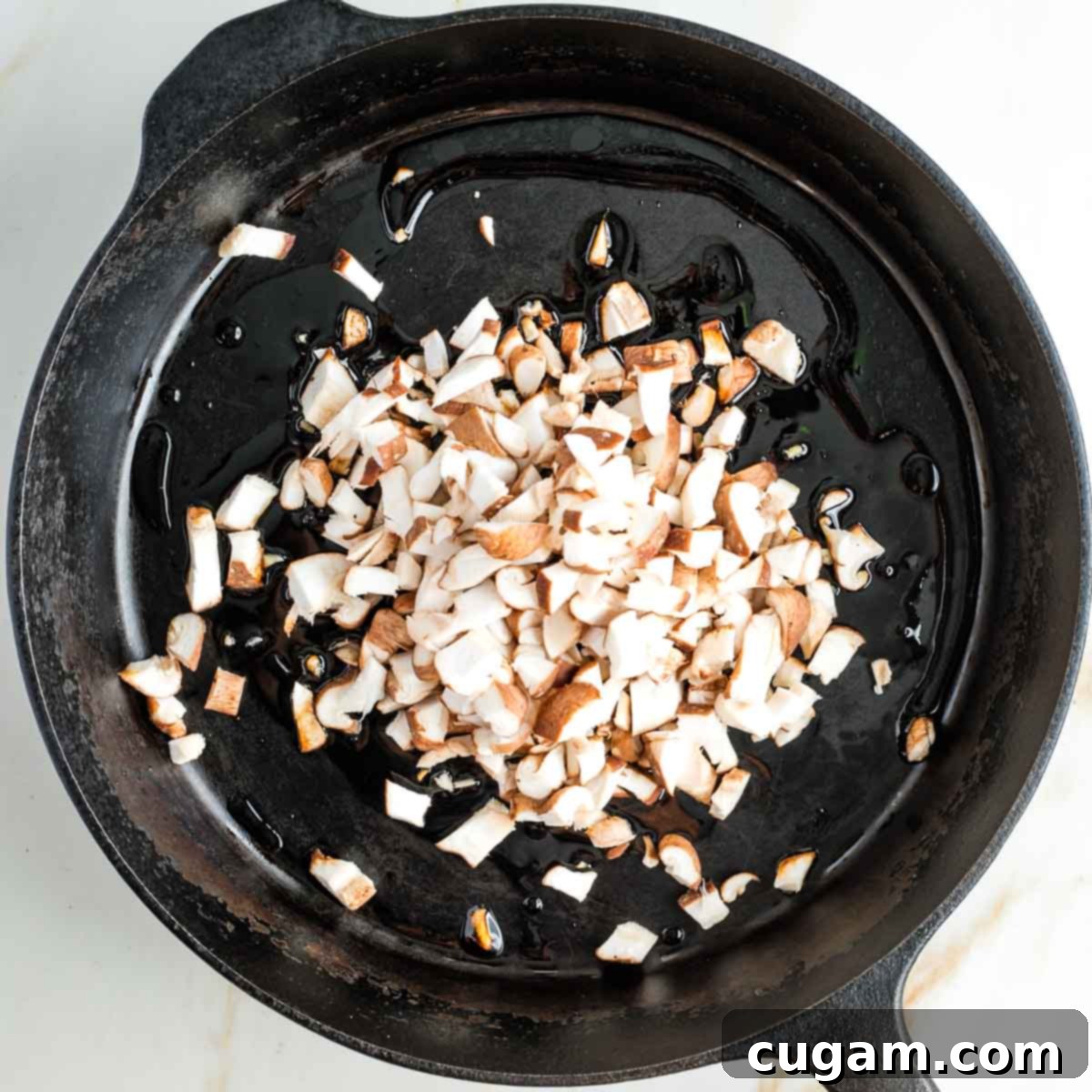 Cast iron skillet with diced shiitake mushrooms.