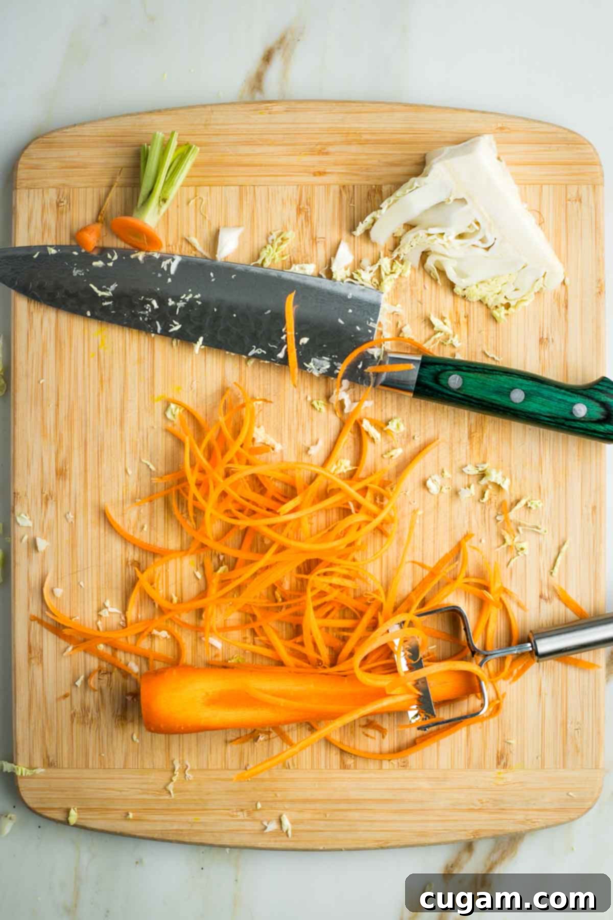 Zesty Russian Slaw 5 Using a julienne peeler on a carrot to create long and super thin slices.