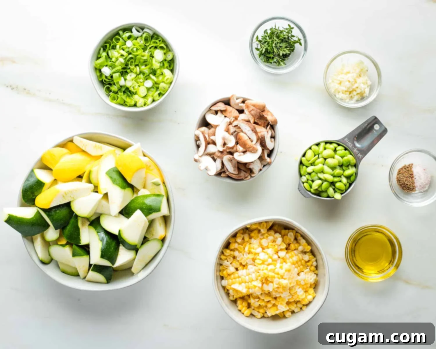 All chopped fresh ingredients, including garlic and herbs, ready to be added to the zucchini skillet dinner.