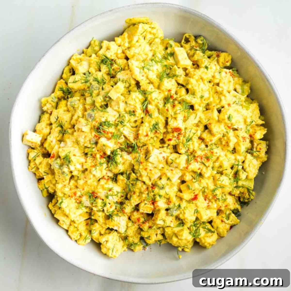 Chunks of celery, scallions and fresh dill and what looks like egg salad, sprinkled with paprika. 
