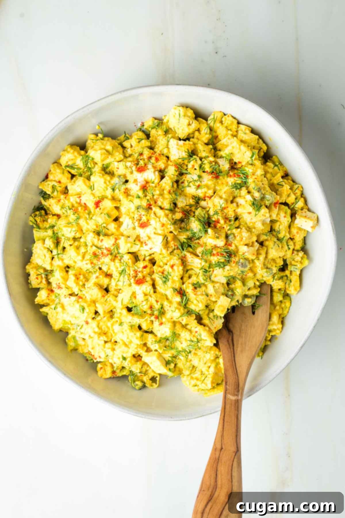 Chunky tofu egg salad with celery, fresh dill and sprinkled on top with paprika.