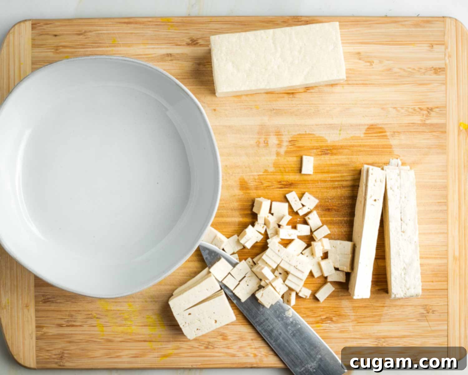 Half a block of tofu cut into slices and then turned on its side to turn those into small diced cubes. 