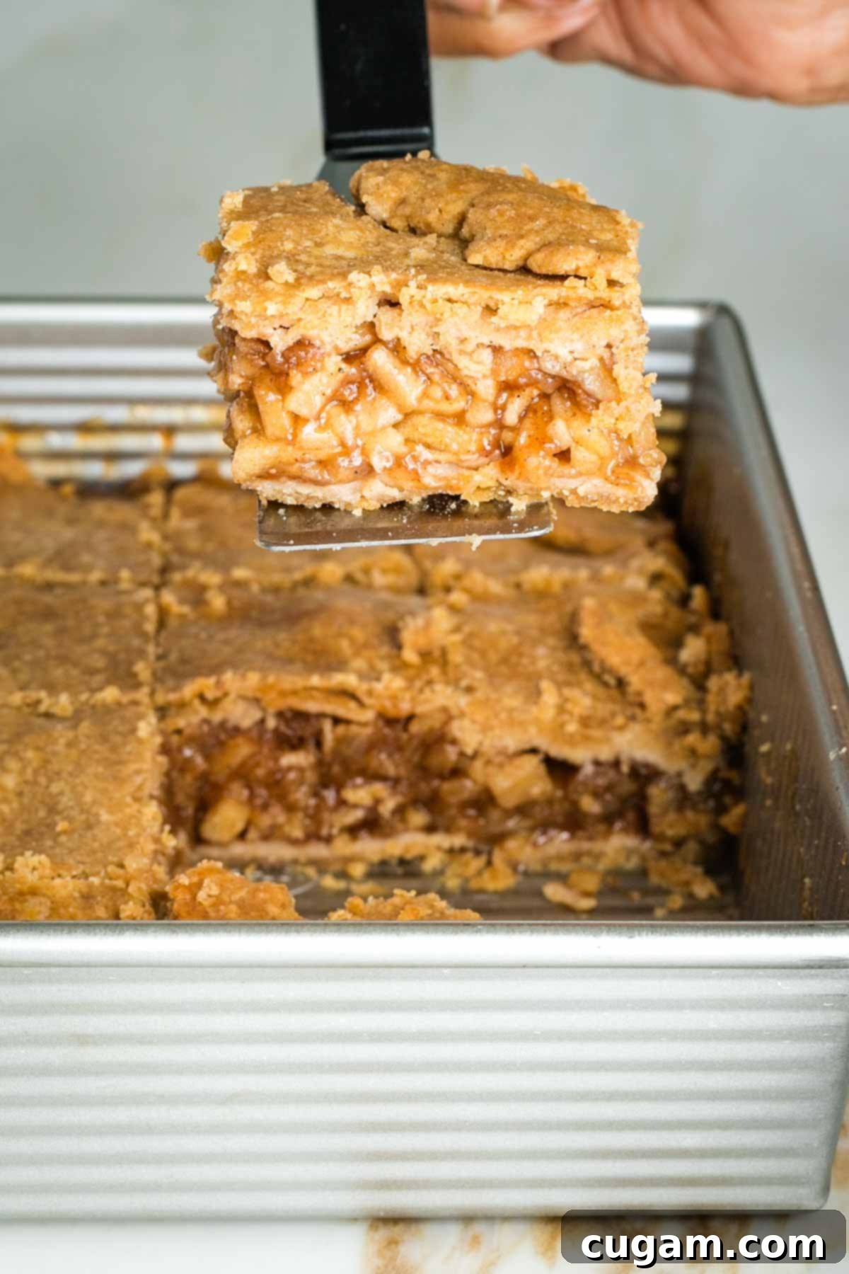 Apple pie bars stored in an airtight container in the refrigerator.