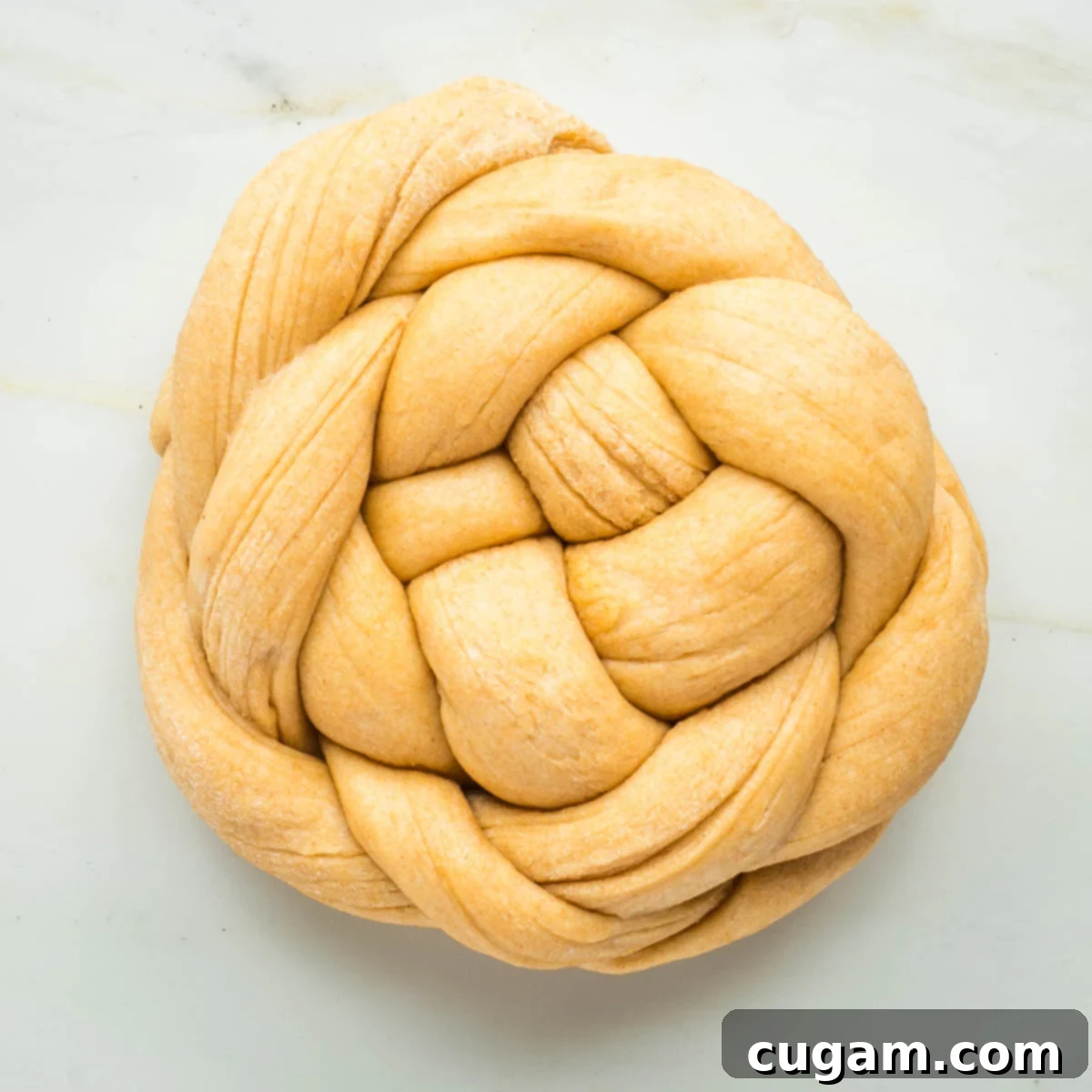 Golden Sweet Round Challah 38 Round loaf of bread created with a braided pattern.