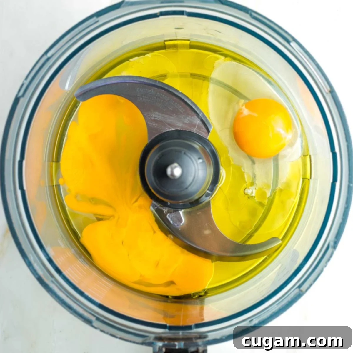 Golden Sweet Round Challah 8 Eggs and oil in the bowl of a food processor.