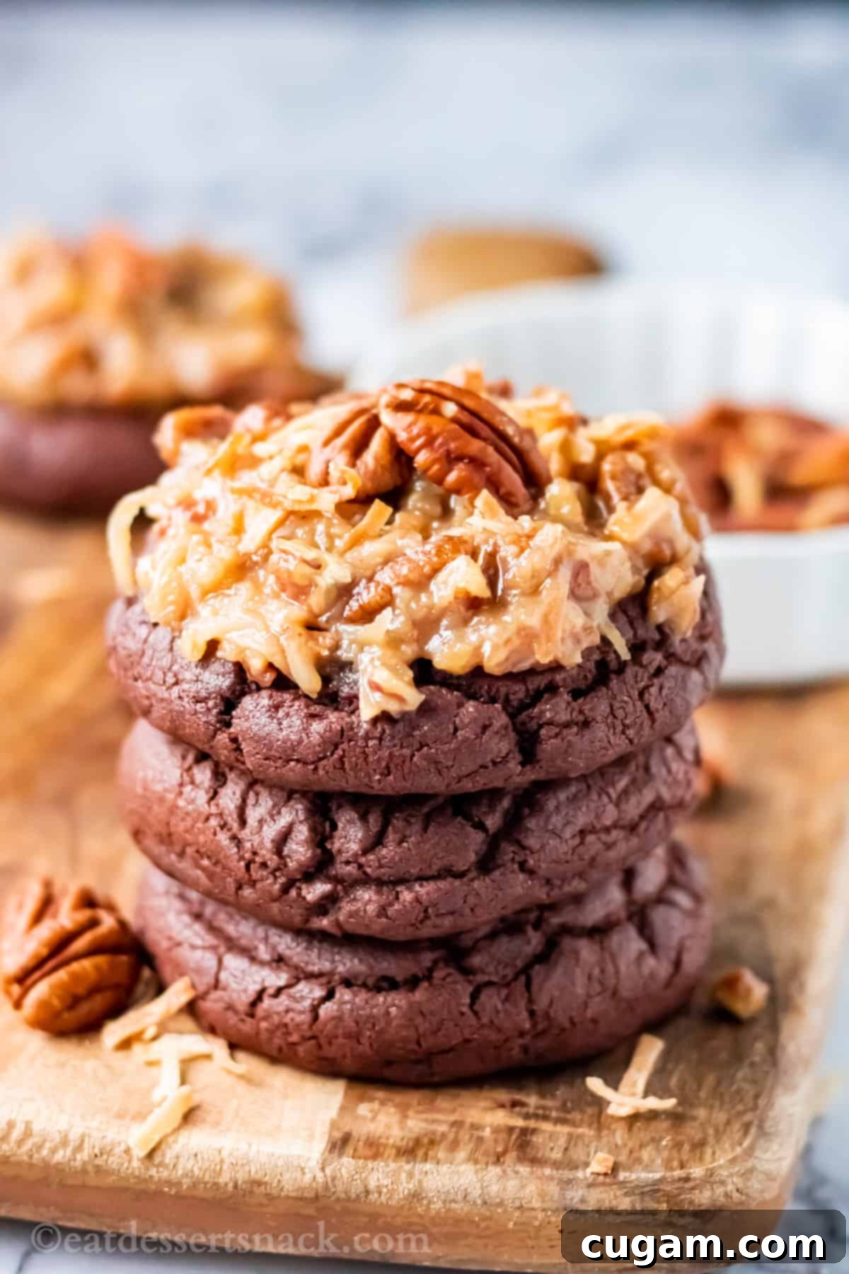 Stacked baked german chocolate cookies on wood board. 