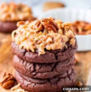 Stacked baked german chocolate cookies on wood board.