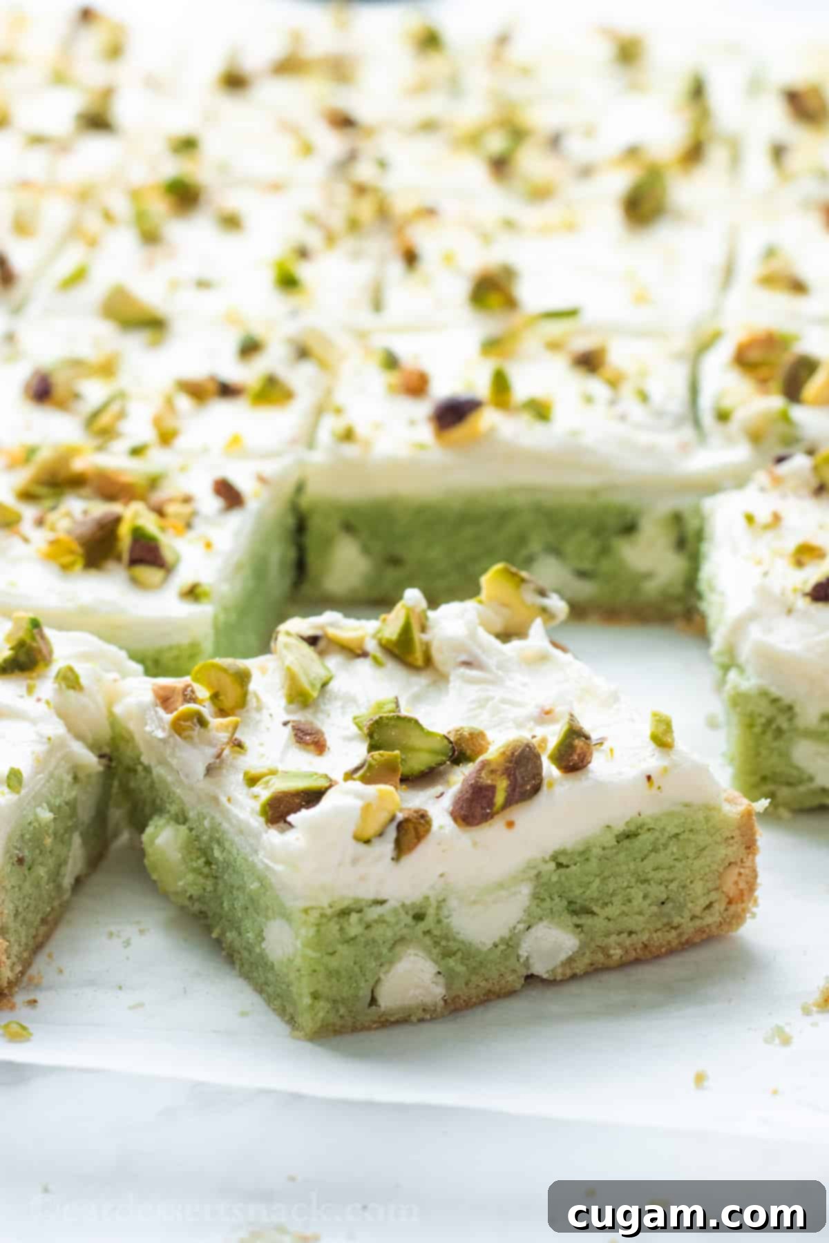 Sliced pistachio bars on parchment paper. 