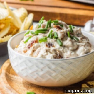 Caramelized Onion Dip in White Bowl on wood board.