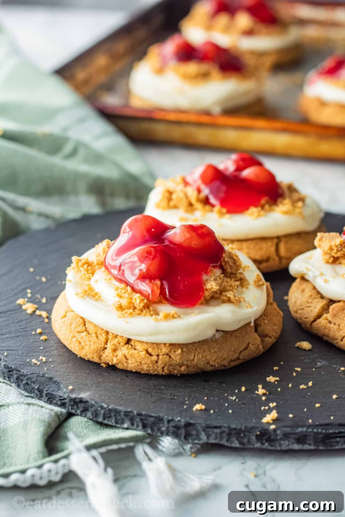 Baked cherry cheesecake cookies on black slate. 