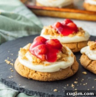 Baked cherry cheesecake cookies on black slate.
