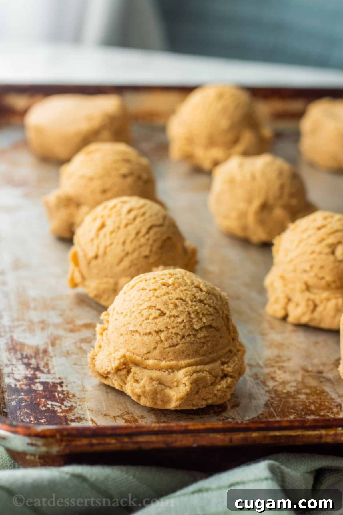Raw cherry cheesecake cookie dough on metal baking sheet. 