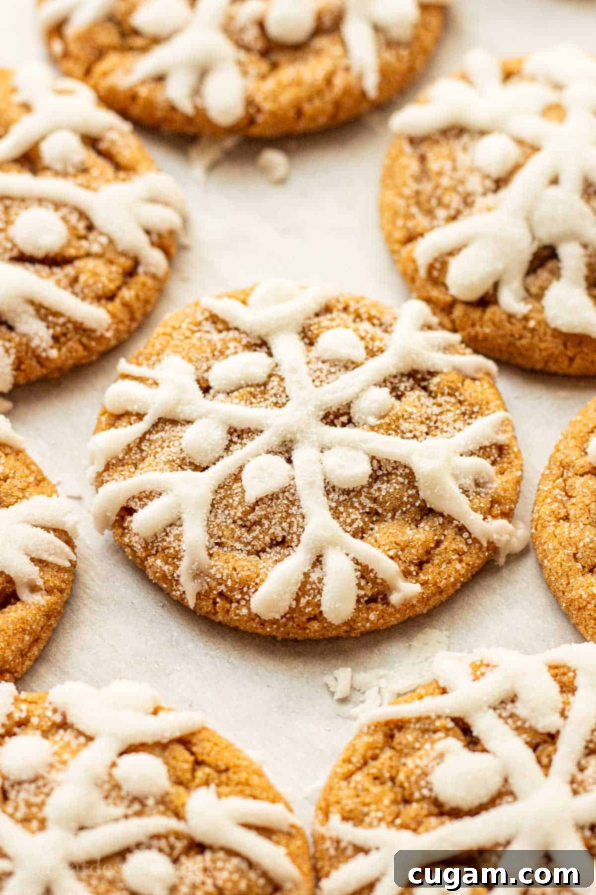 Baked iced molasses cookies on baking sheet.
