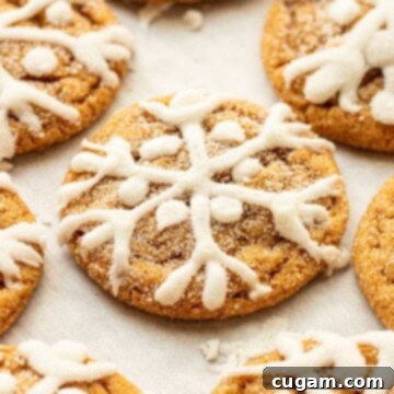 Baked iced molasses cookies on baking sheet.