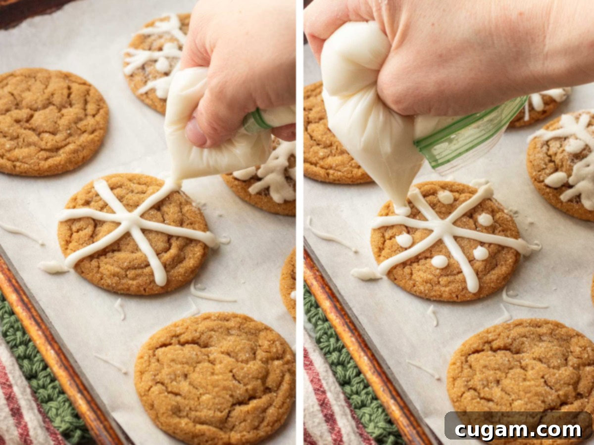 Hand holding icing bag piping icing onto chewy molasses cookies.