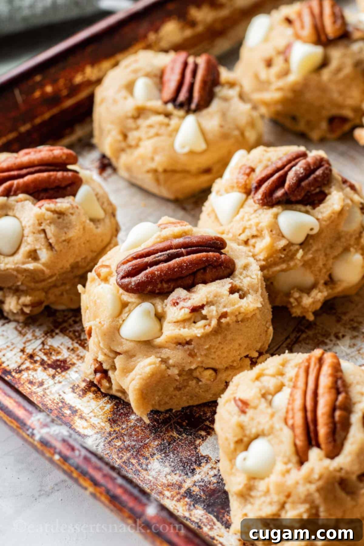 Raw Maple Cookie Dough balls on metal baking pan.