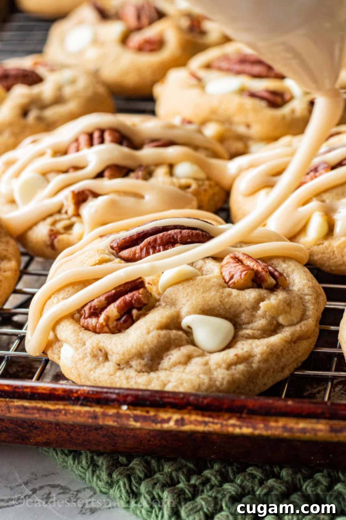 Baked Maple Cookie with icing drizzling over it on metal pan.