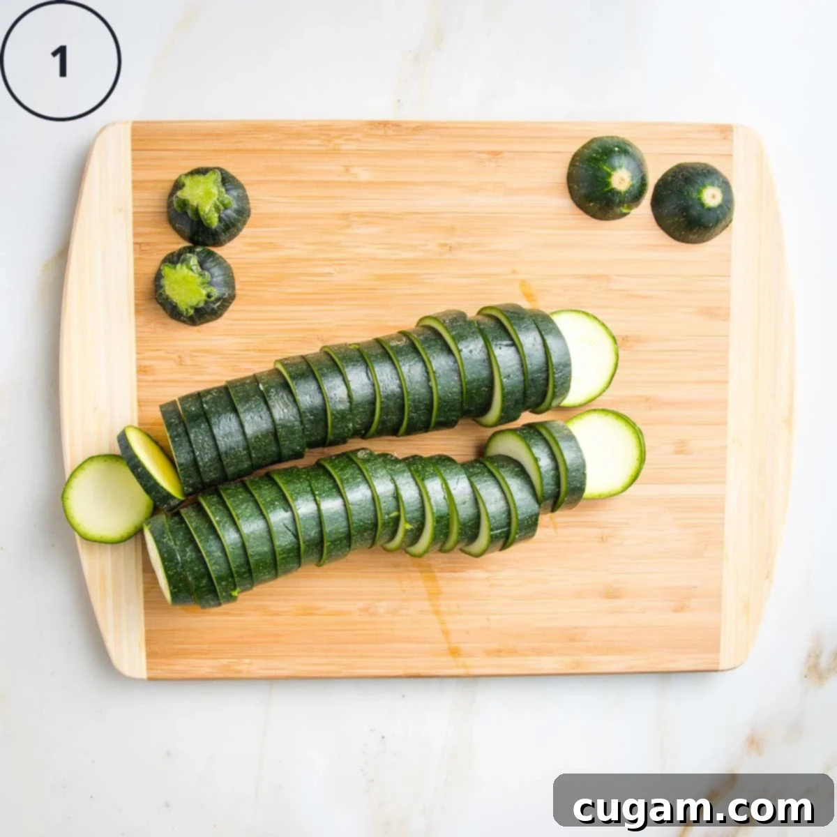 Quick Zucchini Pizza Bites 5 2 Zucchinis sliced into ¼" rounds on a wooden board.