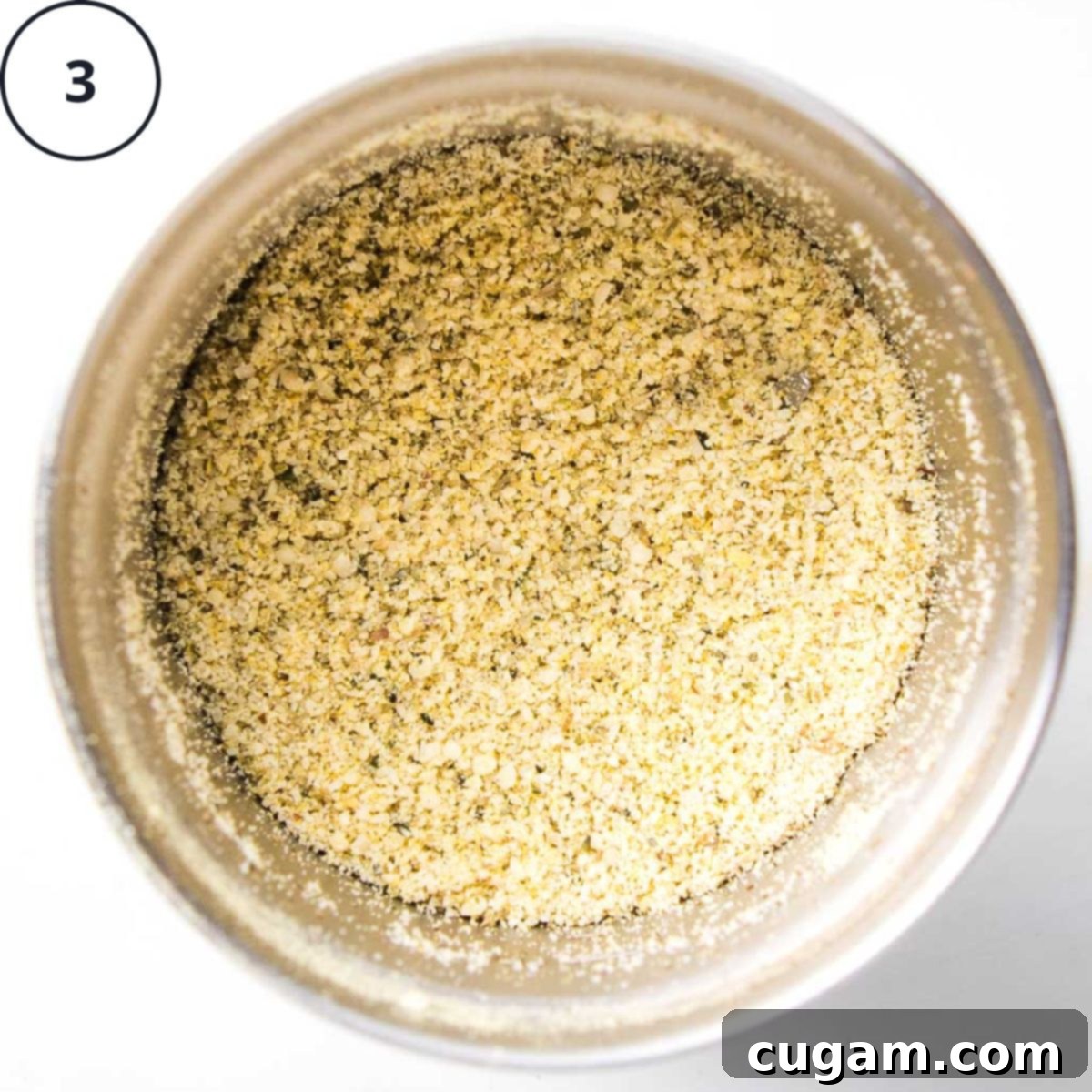 Vegan parmesan in a spice grinder, made with hemp seeds, nutritional yeast and spices ground together.