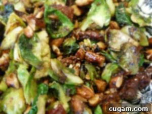 Close-up of perfectly cooked Brussels sprouts with sun-dried tomatoes and crunchy almonds