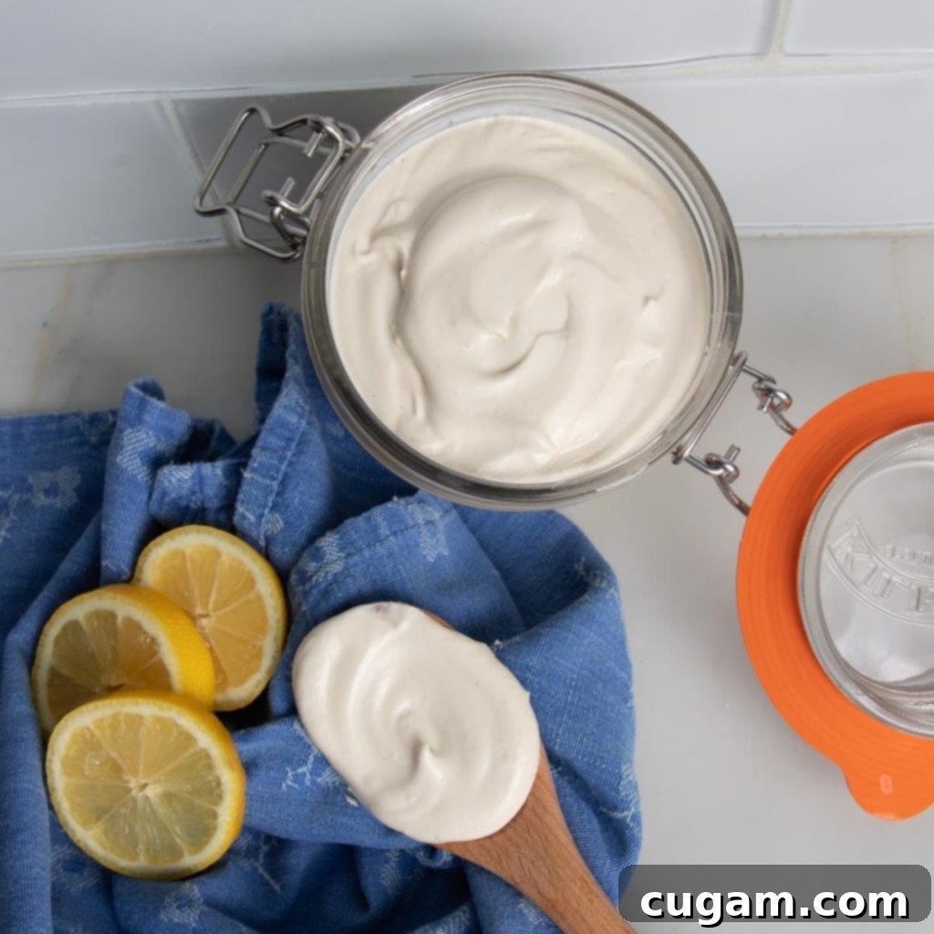 Homemade vegan mayonnaise in a small glass jar.