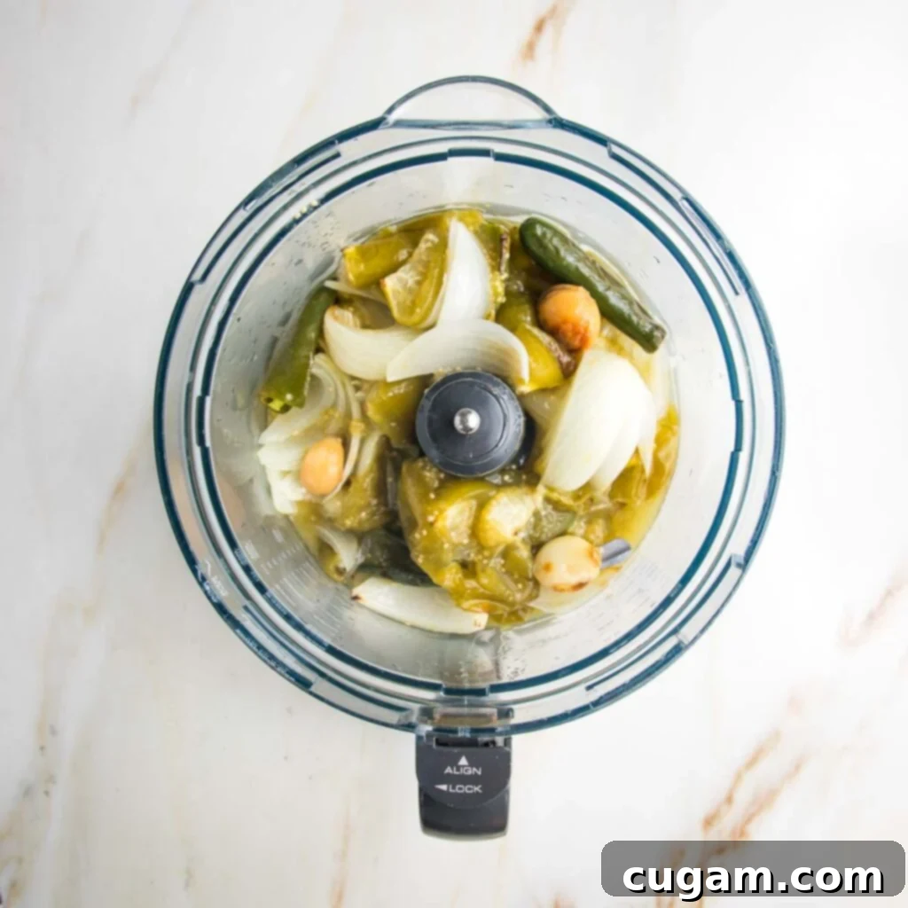 Zesty Roasted Tomatillo Salsa 8 Roasted vegetables being added to a food processor.