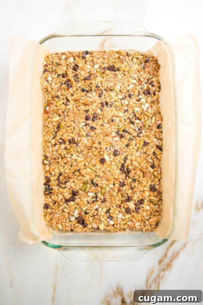 granola bars in a glass dish lined with parchment