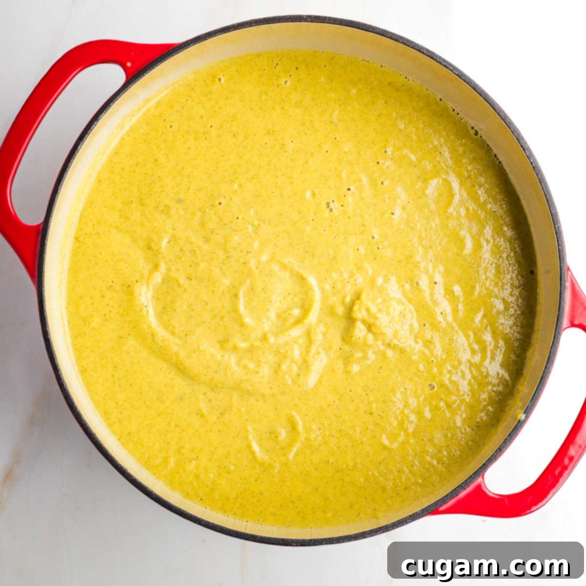 Creamy vegan broccoli soup being blended to a smooth consistency.