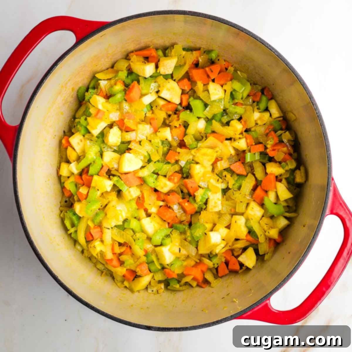 Dutch oven with sauteed diced vegetables. 